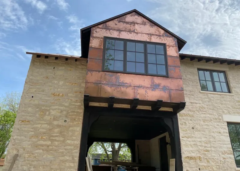 Copper metal panel facade on a stone building for Metal Roof Coating in Cottage Lake